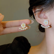 Girl Showing Pearl Flower Earrings 
